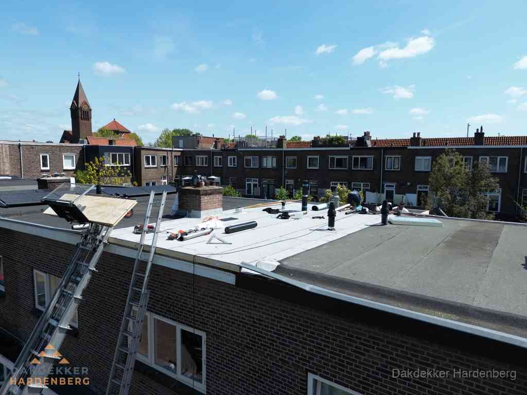Dakdekkers aan het werk op plat dak in Hardenberg